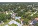 Overhead view of residences in a neighborhood with lush trees, manicured lawns and some backyard pools at 3117 Pine Tree Dr, Edgewater, FL 32141