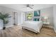 Cozy bedroom with a ceiling fan, ensuite bathroom, and a bright window at 3117 Pine Tree Dr, Edgewater, FL 32141
