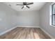Minimalist bedroom with ceiling fan and large window, ready for personalized décor at 3117 Pine Tree Dr, Edgewater, FL 32141