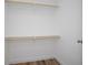 Neat walk-in closet with wood shelves, designed for efficient storage solutions at 3117 Pine Tree Dr, Edgewater, FL 32141