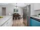 Open floor plan featuring a dining room with modern chandelier adjacent to the kitchen at 3117 Pine Tree Dr, Edgewater, FL 32141