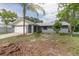 Charming single-story home featuring a metal roof, attached garage, and well-maintained front lawn at 3117 Pine Tree Dr, Edgewater, FL 32141