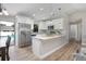 Modern kitchen with white cabinets, granite countertops, stainless steel appliances, and access to the backyard pool at 3117 Pine Tree Dr, Edgewater, FL 32141