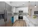 Modern kitchen with white cabinets, granite countertops, and stainless steel appliances at 3117 Pine Tree Dr, Edgewater, FL 32141