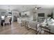 Open floor plan showcasing a stylish living room connected to the kitchen and dining area with hardwood flooring at 3117 Pine Tree Dr, Edgewater, FL 32141