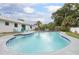 Large pool with landscaped edge and a seating area at 3117 Pine Tree Dr, Edgewater, FL 32141