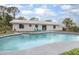 Back of house with outdoor pool and a seating area at 3117 Pine Tree Dr, Edgewater, FL 32141