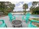 Outdoor seating area with pool surrounded by lush trees and landscaping at 3117 Pine Tree Dr, Edgewater, FL 32141