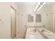 Well-lit bathroom showcasing a vanity sink with a large mirror and a walk-in shower with glass door at 325 Homewood Ave # 10I, Debary, FL 32713