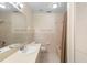 Bright bathroom featuring a large mirror, sink, toilet, and bathtub with tile backsplash and shower curtain at 325 Homewood Ave # 10I, Debary, FL 32713