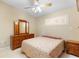 Cozy bedroom with ceiling fan, shuttered window, and tile floors plus a floral patterned bedspread at 325 Homewood Ave # 10I, Debary, FL 32713