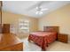 A bright bedroom with a large window features tile floors and traditional-style furniture at 325 Homewood Ave # 10I, Debary, FL 32713