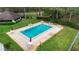 Aerial view of the community pool and sun deck with lounge chairs and tables under umbrellas at 325 Homewood Ave # 10I, Debary, FL 32713