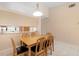 Well-lit dining area featuring a wooden table with seating, and a view of the kitchen at 325 Homewood Ave # 10I, Debary, FL 32713