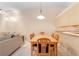 Bright dining area adjacent to the living room, featuring a wooden table and seating for six at 325 Homewood Ave # 10I, Debary, FL 32713