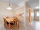 Cozy dining area featuring a wooden table, six chairs, and an overhead pendant light at 325 Homewood Ave # 10I, Debary, FL 32713