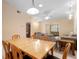 An open floor plan that showcases the dining room with wood table and the living room with comfortable seating at 325 Homewood Ave # 10I, Debary, FL 32713