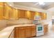 A traditional style kitchen offers lots of cabinet space, modern white appliances, and plenty of natural light at 325 Homewood Ave # 10I, Debary, FL 32713