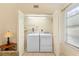 Bright laundry closet featuring a stacked washer and dryer, plus overhead lighting and storage space at 325 Homewood Ave # 10I, Debary, FL 32713