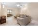 Spacious living room featuring tile flooring, a neutral color palette, and comfortable seating at 325 Homewood Ave # 10I, Debary, FL 32713