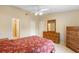 A bright main bedroom features a ceiling fan, tile floors, a walk-in closet, and an ensuite bathroom at 325 Homewood Ave # 10I, Debary, FL 32713