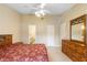 This main bedroom features an ensuite bathroom, tile floors and a ceiling fan at 325 Homewood Ave # 10I, Debary, FL 32713