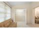 Bright room with tile floors and wide closet with white wire shelving for storage at 325 Homewood Ave # 10I, Debary, FL 32713