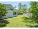 Backyard of the property with mature trees, privacy fence and well-maintained lawn at 3428 Longleaf Rd, Ormond Beach, FL 32174
