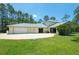 A large backyard with manicured lawn with attached garage, mature landscaping, and a private feel at 3428 Longleaf Rd, Ormond Beach, FL 32174