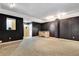 Finished basement with gray carpet, dark walls, wet bar, and access to a separate room at 3428 Longleaf Rd, Ormond Beach, FL 32174
