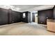 Finished basement with gray carpet, dark walls, wet bar, and access to a separate room at 3428 Longleaf Rd, Ormond Beach, FL 32174