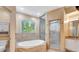 Serene bathroom with a soaking tub, a separate shower, and a vanity with storage at 3428 Longleaf Rd, Ormond Beach, FL 32174