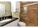 Bathroom featuring a shower with glass doors and a black granite countertop, providing essential amenities at 3428 Longleaf Rd, Ormond Beach, FL 32174