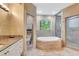 Luxurious bathroom with a large soaking tub, separate shower, and granite countertops at 3428 Longleaf Rd, Ormond Beach, FL 32174