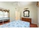 This bedroom features a mirrored closet, a ceiling fan, and a wood dresser at 3428 Longleaf Rd, Ormond Beach, FL 32174