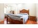This bedroom features a mirrored closet, a wood bed frame, and a wood night stand at 3428 Longleaf Rd, Ormond Beach, FL 32174
