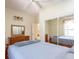 This bedroom features a mirrored closet, a ceiling fan, and a window with curtains at 3428 Longleaf Rd, Ormond Beach, FL 32174