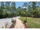 Long driveway leading to the home, framed by trees and greenery at 3428 Longleaf Rd, Ormond Beach, FL 32174