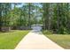 Long driveway leading up to the house behind a secure gate with a privacy fence at 3428 Longleaf Rd, Ormond Beach, FL 32174