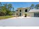 Two-story home with manicured lawn, mature trees, palm tree, and a long driveway at 3428 Longleaf Rd, Ormond Beach, FL 32174