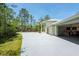 Two-story home with a long driveway, manicured lawn, and an attached garage at 3428 Longleaf Rd, Ormond Beach, FL 32174