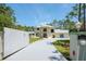 Two-story home featuring a circular driveway, lush lawn, and mature trees at 3428 Longleaf Rd, Ormond Beach, FL 32174