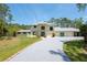 Spacious home featuring a long driveway, lush lawn, and well-maintained landscaping at 3428 Longleaf Rd, Ormond Beach, FL 32174