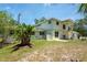The back of the home shows large windows with an expansive backyard at 3428 Longleaf Rd, Ormond Beach, FL 32174