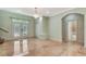 Elegant foyer features marble floors, a crystal chandelier, closet, and stained-glass front doors at 3428 Longleaf Rd, Ormond Beach, FL 32174