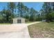 Well-maintained detached garage next to a long driveway with ample green space at 3428 Longleaf Rd, Ormond Beach, FL 32174