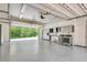 Spacious garage with epoxy flooring, storage cabinets, and stainless steel washer and dryer at 3428 Longleaf Rd, Ormond Beach, FL 32174