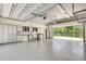Spacious garage with epoxy floor, ample storage cabinets, laundry area, and open door at 3428 Longleaf Rd, Ormond Beach, FL 32174