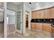 Bright kitchen with wood cabinets, granite countertops, pantry, and decorative glass door at 3428 Longleaf Rd, Ormond Beach, FL 32174