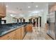 Open kitchen with wood cabinets, black granite counters, and stainless steel appliances at 3428 Longleaf Rd, Ormond Beach, FL 32174